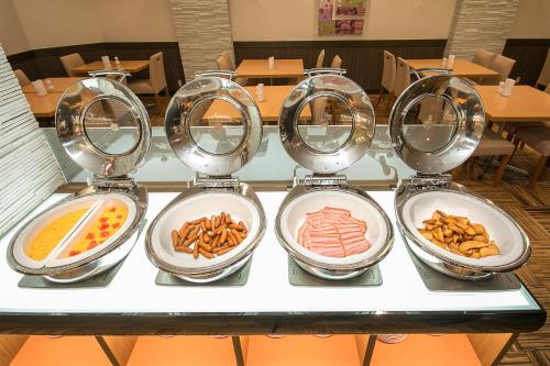 four plates with different types of food on a table at Hotel Hokke Club Fukuoka in Fukuoka