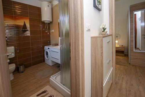 a bathroom with a shower and a toilet and a sink at Apartment Polic in Šibenik