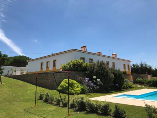 a house with a swimming pool in front of it at A Casa da Andorinha in Salir de Matos