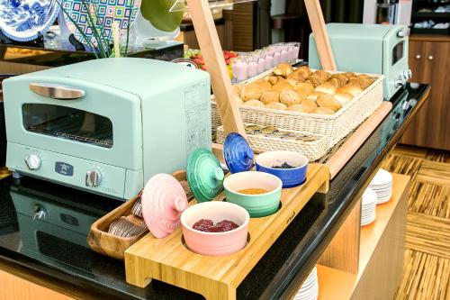 a counter with a toaster and bowls of food at Hotel Hokke Club Fukuoka in Fukuoka