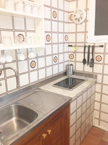 a kitchen with a sink and a counter top at Apartamentos Albertos in Santa Eularia des Riu