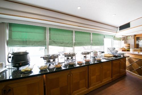 a kitchen with a counter with bowls of food at European Castle歐堡商務汽車旅館有限公司 in Xinying