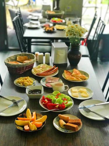 a table with plates of food on it at Sunshine Kazbegi in Stepantsminda