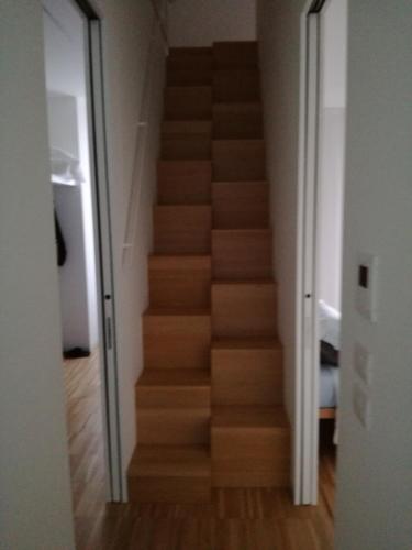 a stairway in a room with a wooden staircase at La casa di Mario tra le case in Ortona