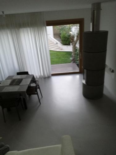 a living room with a table and a room with a window at La casa di Mario tra le case in Ortona