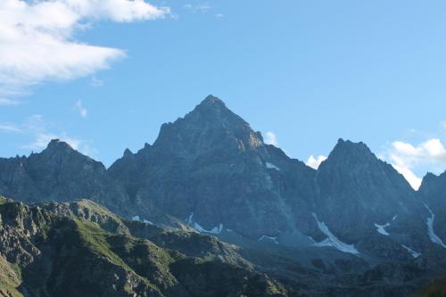 a mountain range with a blue sky and clouds at I "Giardin" in Crissolo