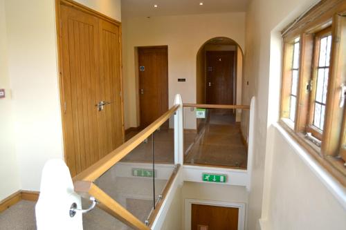 a staircase in a room with a stair case at Pepper Street Rooms in Whitchurch