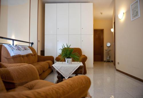 a living room with a couch and chairs and a table at Hotel Centrale di Paolo e Cinzia in Loreto
