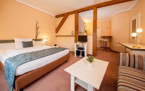 a hotel room with a bed and a couch at Aparthotel Villa Freisleben in Dresden