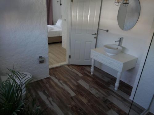 a bathroom with a sink and a mirror at Alaçatı La Vista in Alaçatı