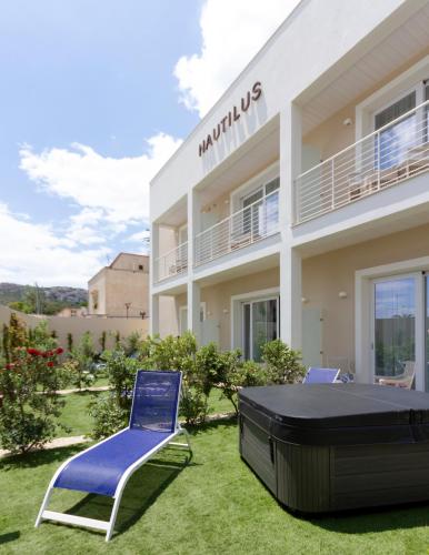 a villa with a lawn in front of a building at Hotel Nautilus in Cagliari