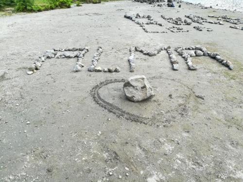 a word written in the sand on a beach at Pés Verdes-Alojamento e Chá in Ponta Delgada