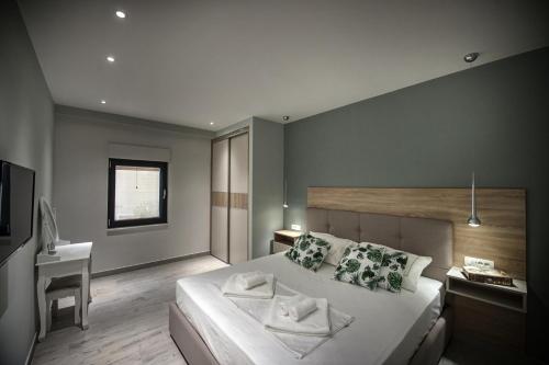 a bedroom with a large white bed and a desk at Villa Amoretta - Pisak (Omiš) in Pisak