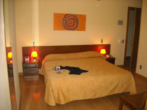a bedroom with a black dog laying on a bed at B&B Casa Sartori in Malcesine