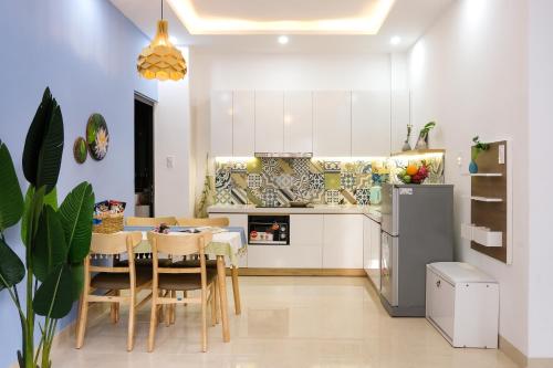 a kitchen and dining room with a table and chairs at Phuong Tran Apartment and Hotel in Da Nang