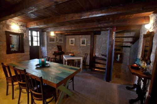a dining room with a wooden table and chairs at Mavromichalai in Limeni