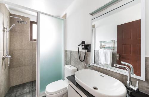 a bathroom with a sink and a toilet and a shower at FOX JAFFNA by Fox Resorts in Jaffna