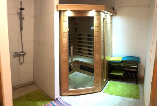 a walk in shower with a glass door in a bathroom at Chata Magistrála in Bedřichov