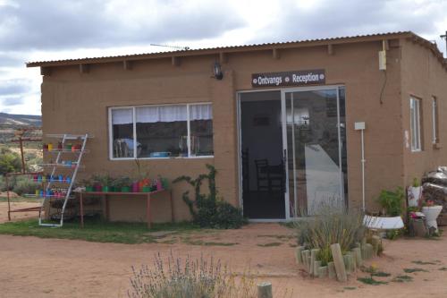 a small building with a door and a window at Sperrgebiet Lodge in Springbok