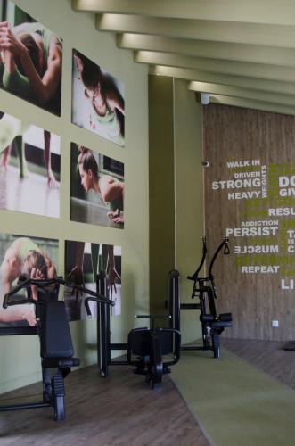 a gym with cardio equipment and posters on the wall at Palala Boutique Game Lodge and Spa in Tom Burke