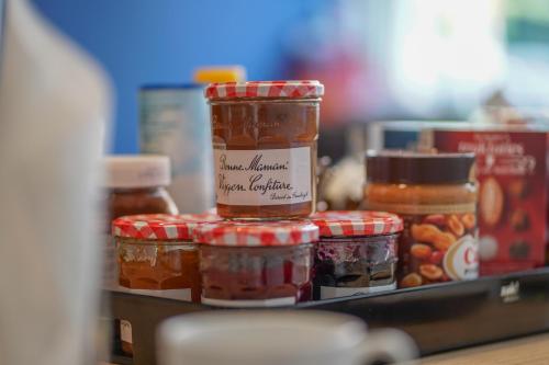 a counter with jars of jam and other food items at Amistad hotel in Amsterdam