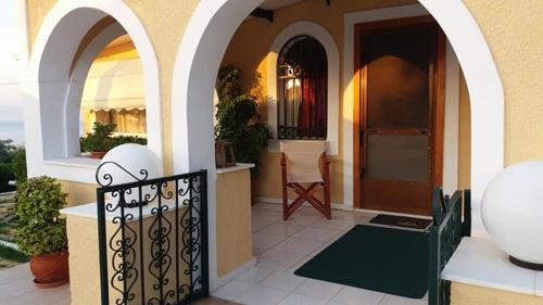 a house with a gate in front of a house at Villa VS in Vathí