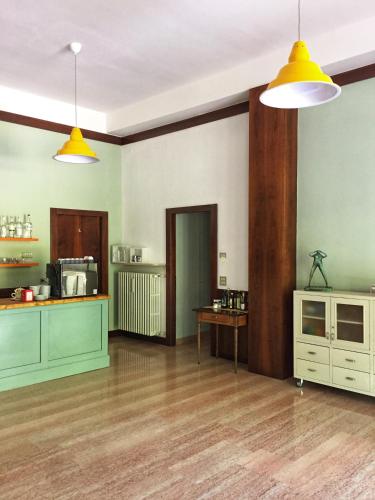a living room with green walls and yellow lights at Ostello delle cartiere in Toscolano Maderno
