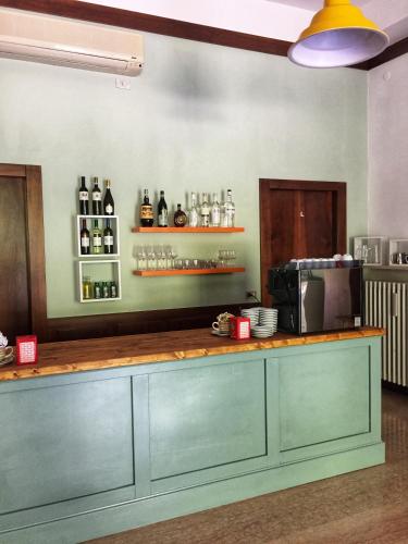 a kitchen with a counter with bottles of wine at Ostello delle cartiere in Toscolano Maderno