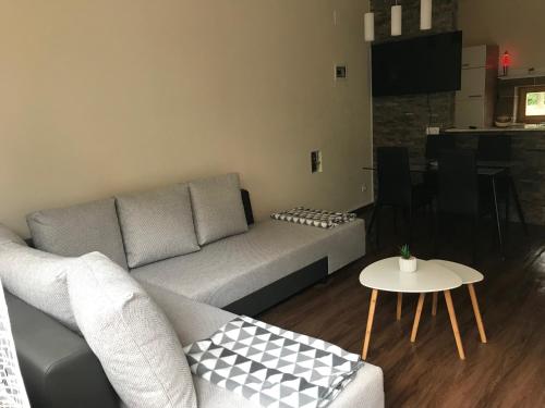 a living room with a couch and a table at Candy Apartman in Keszthely