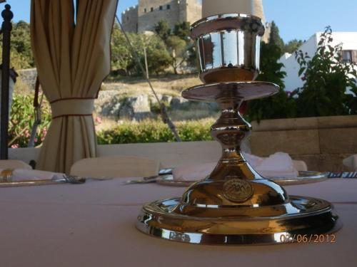 a gold trophy sitting on top of a table at Melenos Art Boutique Hotel in Líndos