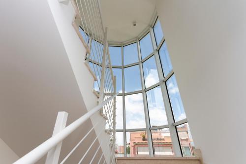 a spiral staircase in a building with a glass ceiling at Hotel Nautilus in Cagliari