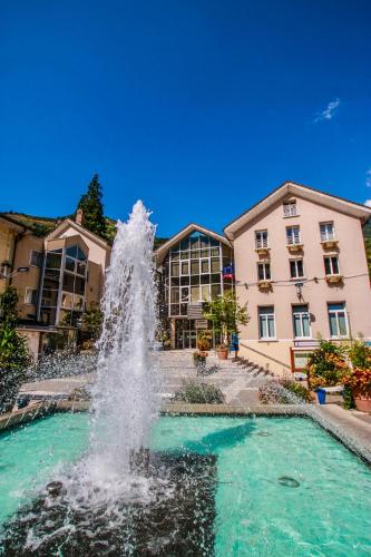a water fountain in front of a building at Résidences Alticimes in Brides-les-Bains