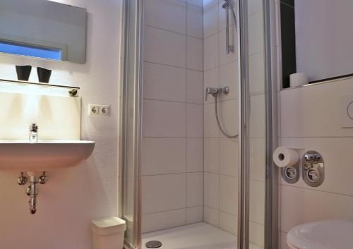 a bathroom with a shower and a sink at Pension Adler in Sonthofen