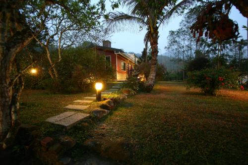 a house with a light in the yard at night at 鋐洋民宿 in Lugu
