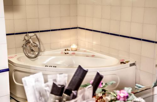 a bathroom with a tub with a candle and a mirror at Agriturismo Sanguineto in Acquaviva