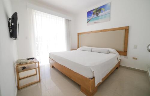 a hotel room with a bed and a desk at Apartamentos Punta Cana by Be Live in Punta Cana