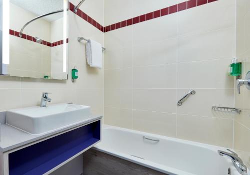a bathroom with a sink, toilet, and shower stall at Jurys Inn Sheffield in Sheffield