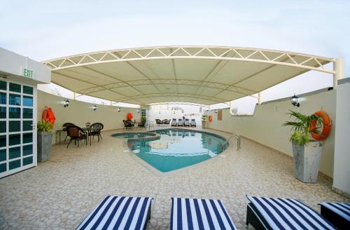 a large swimming pool in a building with a patio at Dream City Hotel Apartments LLC in Dubai