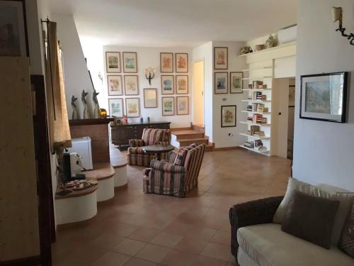 a living room with a couch and chairs and a tv at La casa di Sergio in Brindisi
