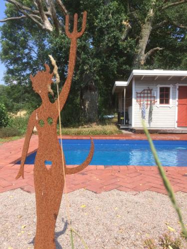 a wooden statue of a woman with her arms in the air at Boråkra Bed & Breakfast in Karlskrona