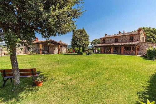 a park with a bench in front of a house at Agriturismo Pian del Vescovo in Massa Marittima