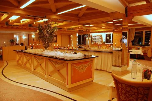 a large kitchen with a large island in a restaurant at Alpenpension Regina in Nauders