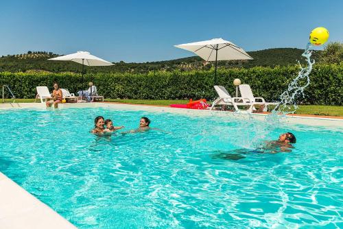 a group of people in a swimming pool at Agriturismo Pian del Vescovo in Massa Marittima