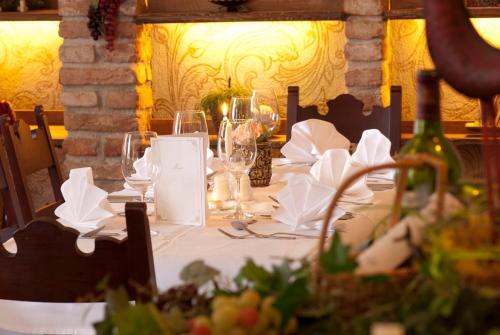 a table with a white table cloth and wine glasses at Alpenpension Regina in Nauders