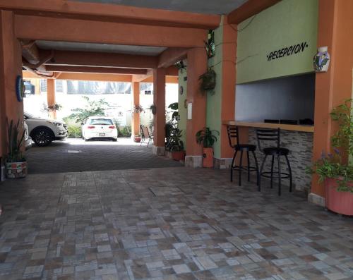 a building with a bar in a parking lot at Oaxaquita la Bella in Oaxaca City