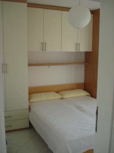 a bedroom with a bed and white cabinets at Appartement "Noni" in Okrug Donji