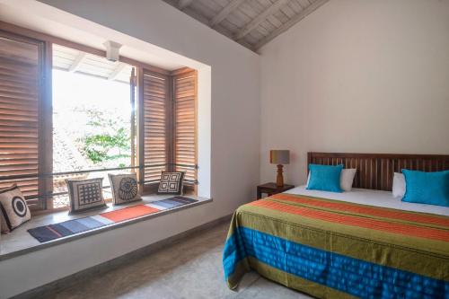 a bedroom with a bed and a large window at 50 CHURCH STREET - GALLE FORT in Galle