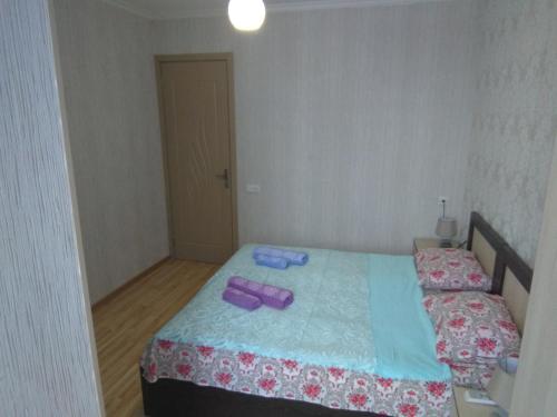 a bedroom with two beds with purple items on it at Irina in Tskaltubo