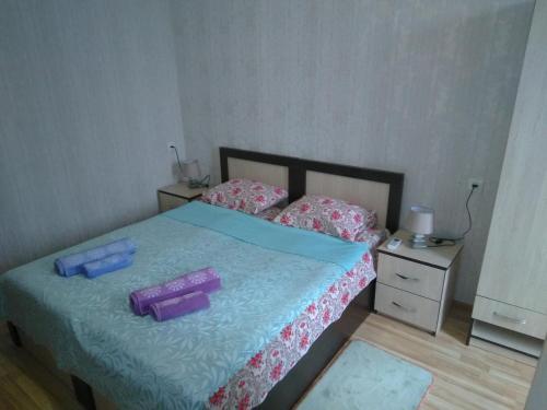 a bedroom with a bed with two containers on it at Irina in Tskaltubo