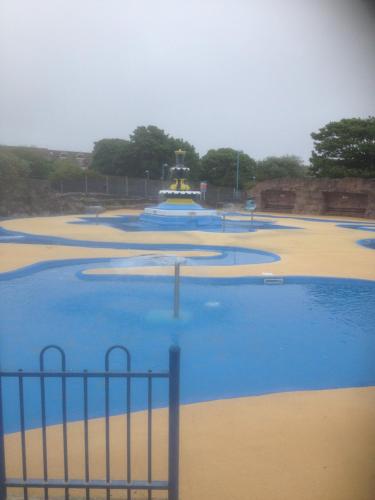 a water park with a fountain in the middle at Serena Court Hotel in Skegness